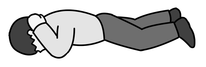 うつ伏せになる人